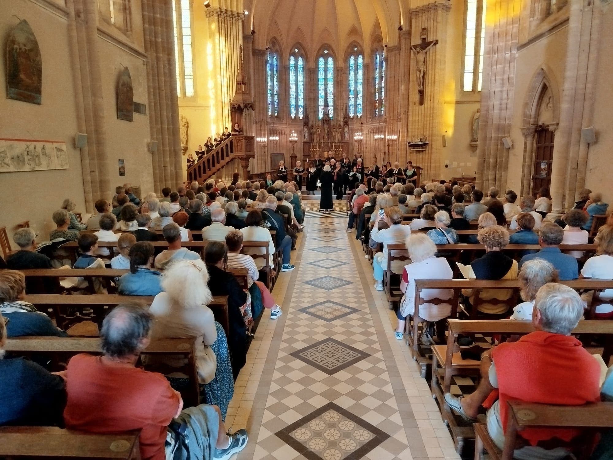 Chico Community Choir performing for a full house in Saint-Aubin-sur-Mer, France
