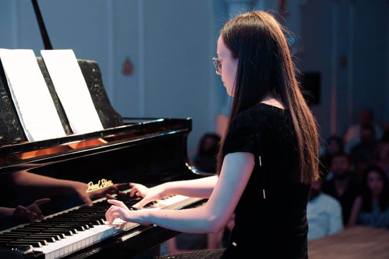 Pianist performing at a grand piano