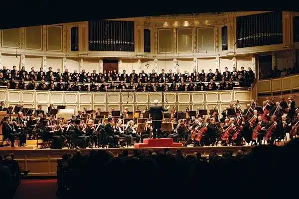 Orchestra and chorus performing in Orchestra Hall at Symphony Center