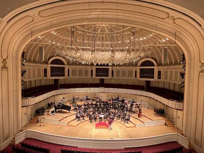 Orchestra rehearsing on stage at Orchestra Hall at Symphony Center