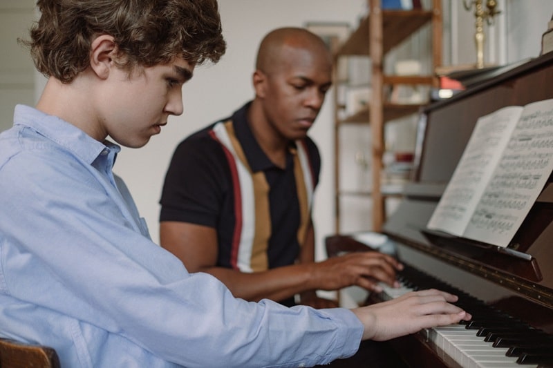 Music educator and student at a piano